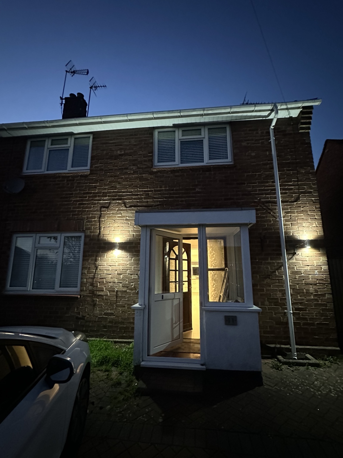 Exterior wall lights illuminated on a house