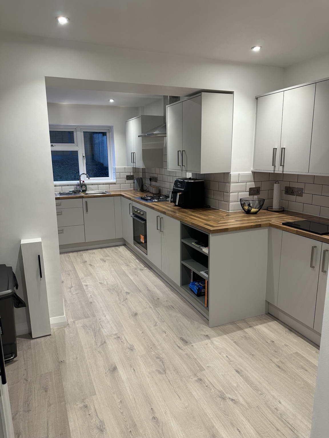 Finished kitchen electrical installation with recessed lighting and sockets
